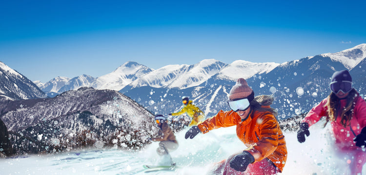 Two people snowboarding in a mountainous winter landscape with clear blue sky. cuchara mountain park ski area, affordable skiing, affordable snowboarding, affordable colorado ski areas, affordable colorado ski resort