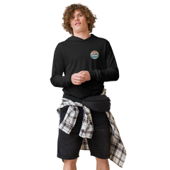 Person wearing a black hoodie with 'Cuchara Mountain Park' logo in a snowy mountain landscape. Person wearing a black hoodie with a logo against a snowy mountain landscape. lightweight long-sleeve hooded tee, unrestricted movement shirt, all-season layering top, comfortable athletic fit, stylish outdoor outfit, year-round trail essential, men's hooded t-shirt, cuchara mountain park hoodie, cuchara mountain park long sleeve shirt