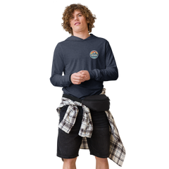 Person wearing a black hoodie with 'Cuchara Mountain Park' logo in a snowy mountain landscape. Person wearing a black hoodie with a logo against a snowy mountain landscape. lightweight long-sleeve hooded tee, unrestricted movement shirt, all-season layering top, comfortable athletic fit, stylish outdoor outfit, year-round trail essential, men's hooded t-shirt, cuchara mountain park hoodie, cuchara mountain park long sleeve shirt