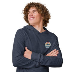 Person wearing a black hoodie with 'Cuchara Mountain Park' logo in a snowy mountain landscape. Person wearing a black hoodie with a logo against a snowy mountain landscape. lightweight long-sleeve hooded tee, unrestricted movement shirt, all-season layering top, comfortable athletic fit, stylish outdoor outfit, year-round trail essential, men's hooded t-shirt, cuchara mountain park hoodie, cuchara mountain park long sleeve shirt