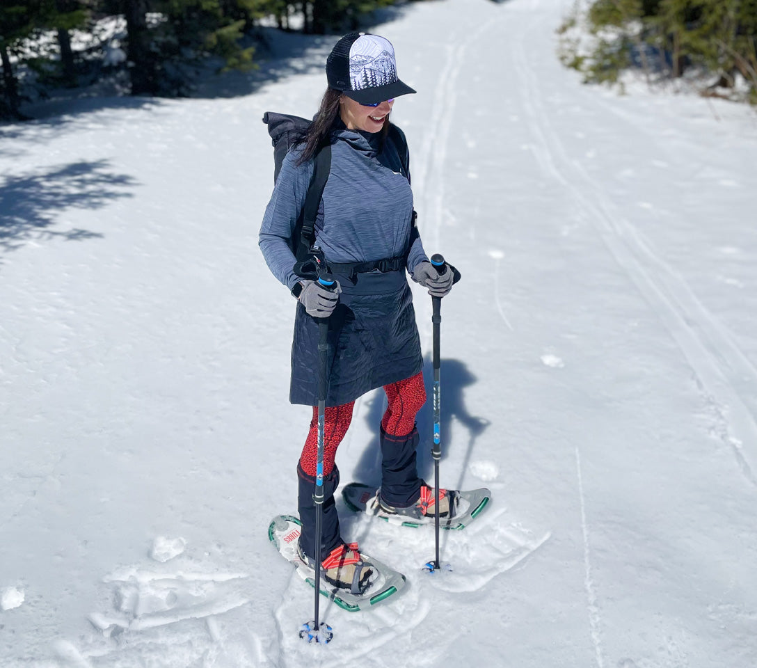 Person snowshoeing in a snowy landscape with trees in the background.  Snowshoer traversing a scenic, deep-snow trail at Cuchara Mountain Park on the Lower Baker Creek route for winter trail exploration.  Cuchara Mountain Park snowshoeing,  Colorado winter trails exploration, scenic high-mountain snowshoe route, snowshoeing on Lower Baker Creek Trail,  Service Road snowshoeing Lift 3, backcountry snow travel CMP,  winter park activity, backcountry snowshoeing