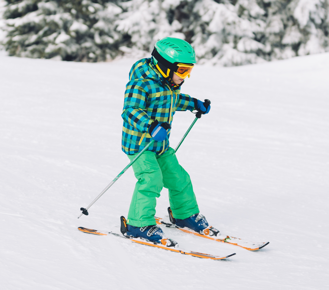 Child skiing in a snowy landscape with trees.  affordable sking, kids ski free at cuchara mountain park, kids scholarship program, kids ski scholarship program 