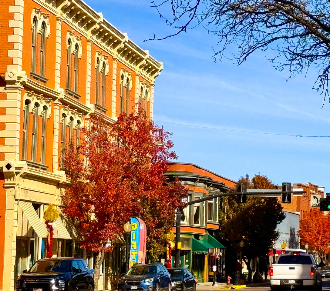 Street scene with autumn trees, buildings, and cars under a clear blue sky.  Trinidad restaurants, trinidad downtown, downtown trinidad