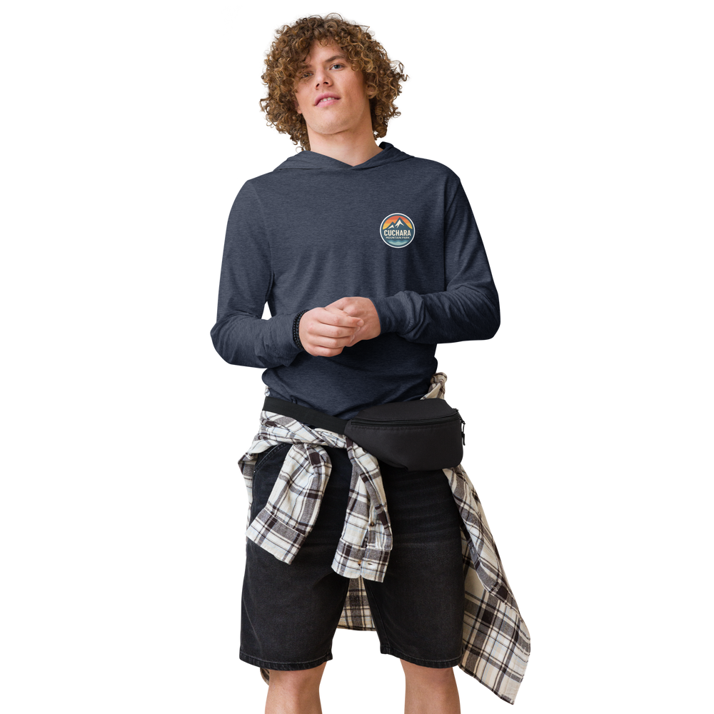 Person wearing a black hoodie with 'Cuchara Mountain Park' logo in a snowy mountain landscape.  Person wearing a black hoodie with a logo against a snowy mountain landscape.  lightweight long-sleeve hooded tee, unrestricted movement shirt, all-season layering top, comfortable athletic fit, stylish outdoor outfit, year-round trail essential, men's hooded t-shirt, cuchara mountain park hoodie, cuchara mountain park long sleeve shirt